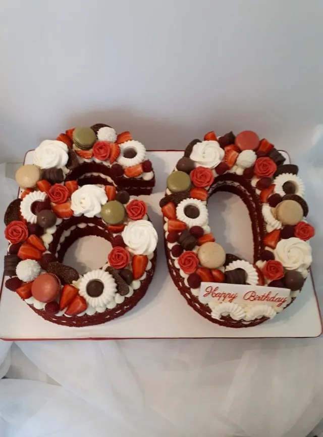 Number 60 cake with red roses, chocolates and macarons