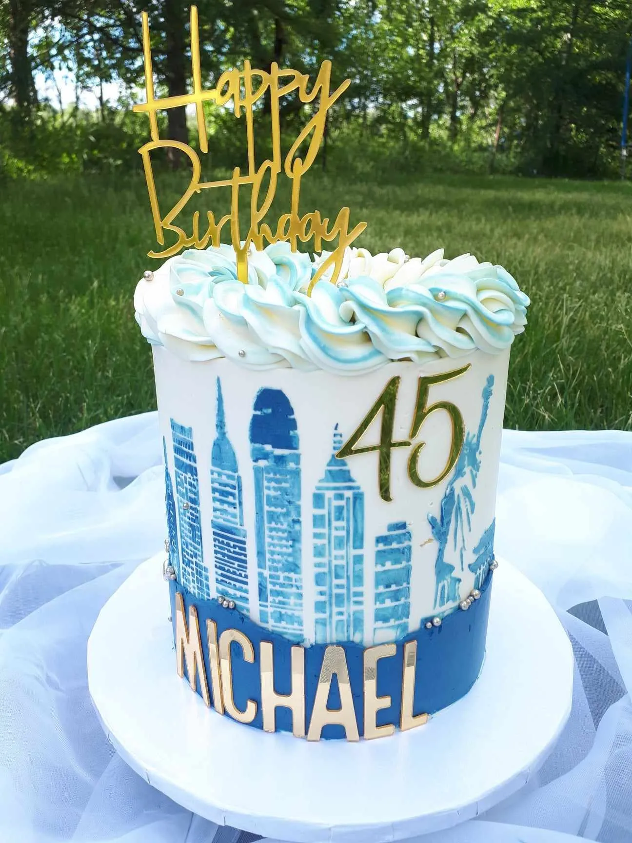 Birthday cake with a blue city skyline and the number 45