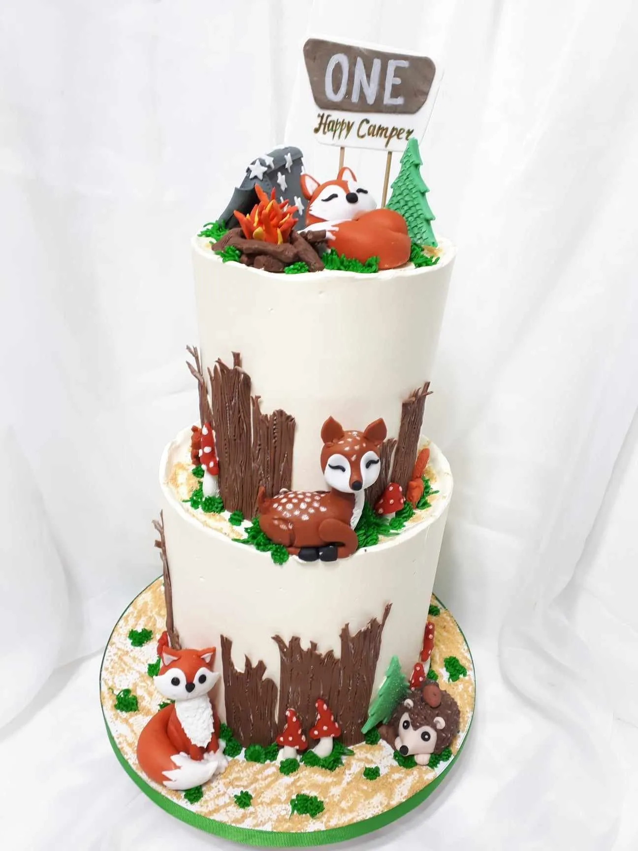 Two-tier camping cake with a fondant fox and a campfire