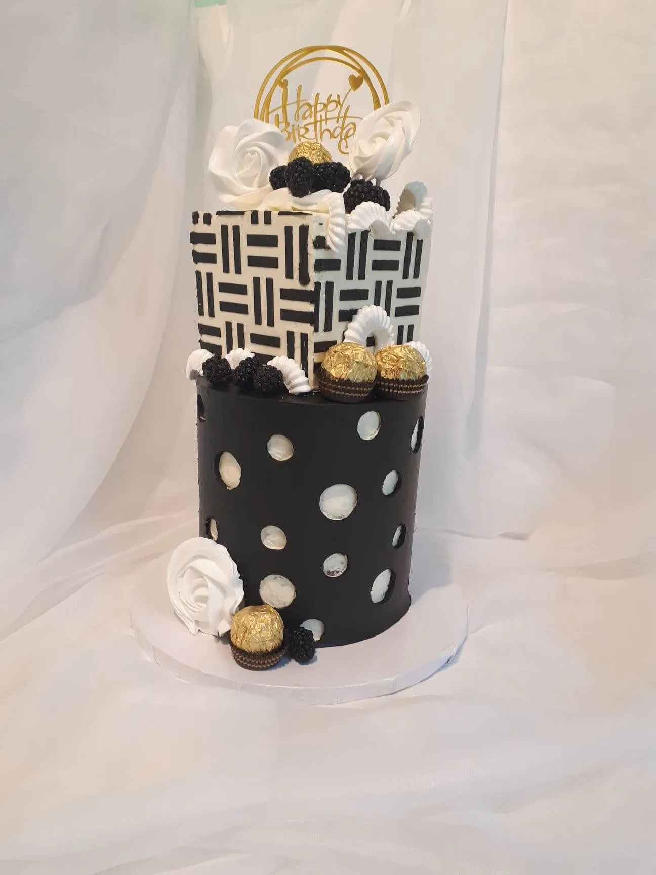 Black and white birthday cake topped with Ferrero Rocher