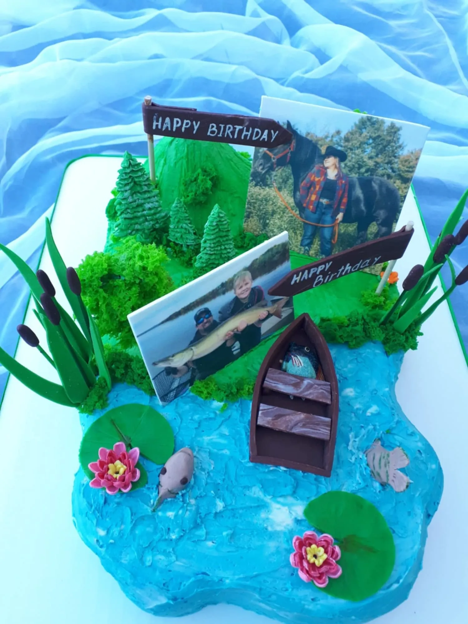 Fishing birthday cake with a lake, a boat and trees