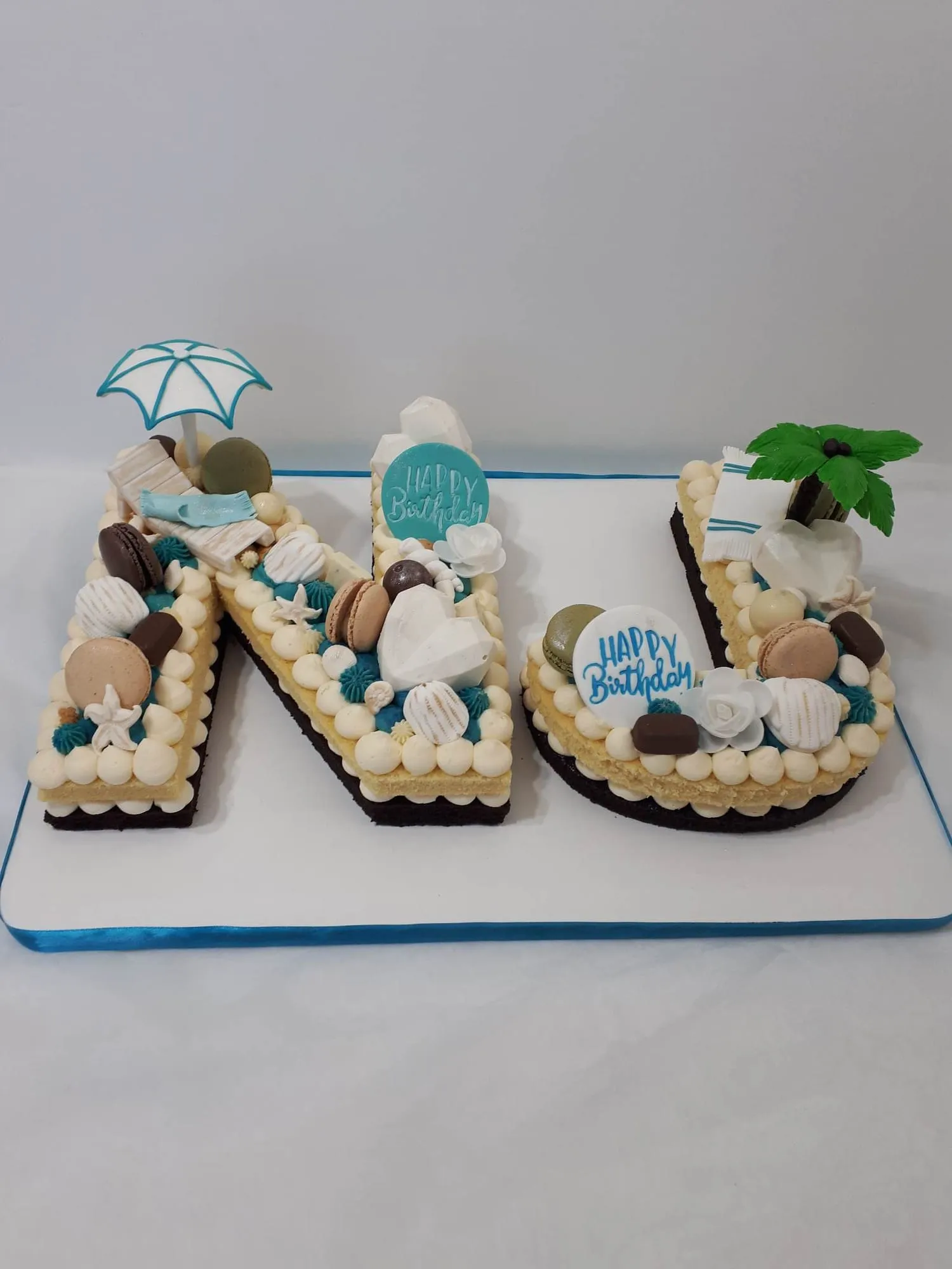 Letter cake with cookies and beach decorations