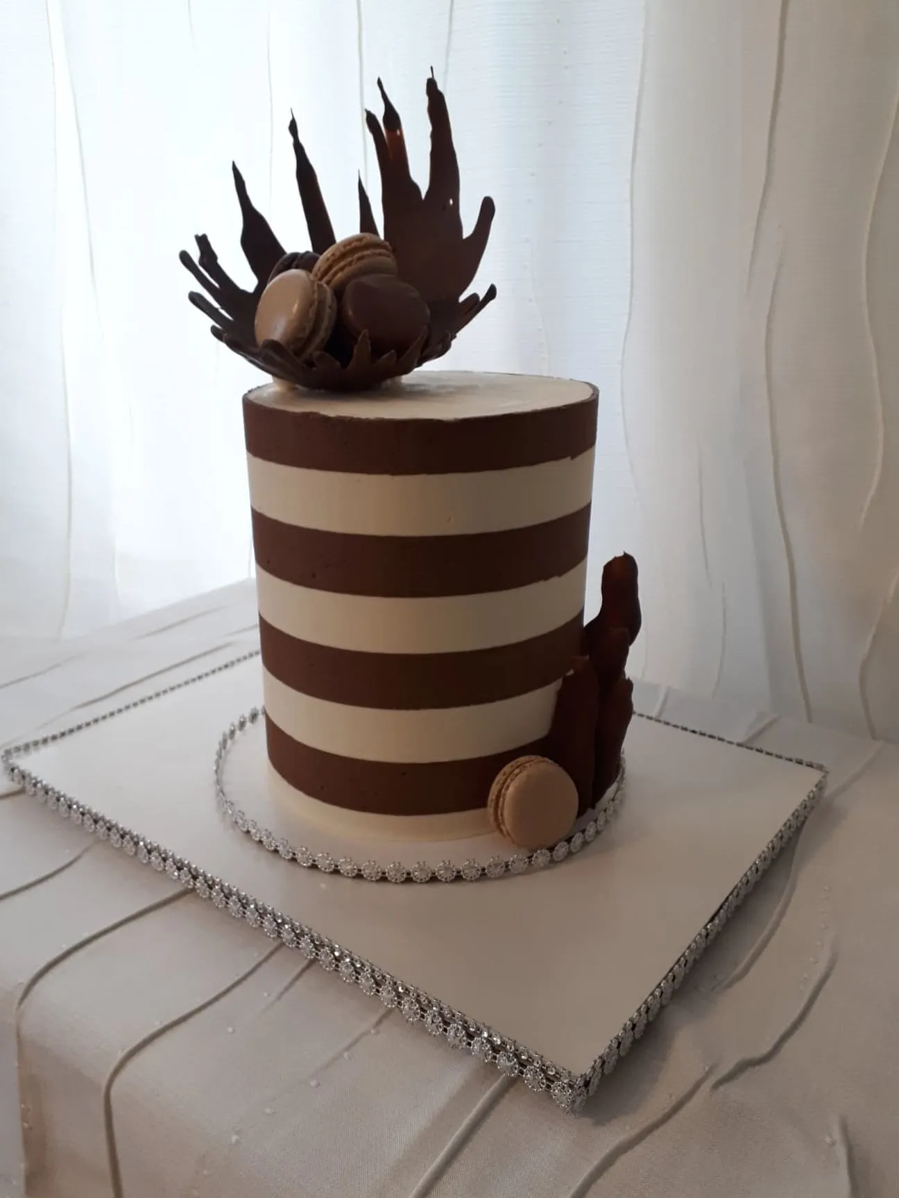 Brown and white striped cake with chocolate decorations