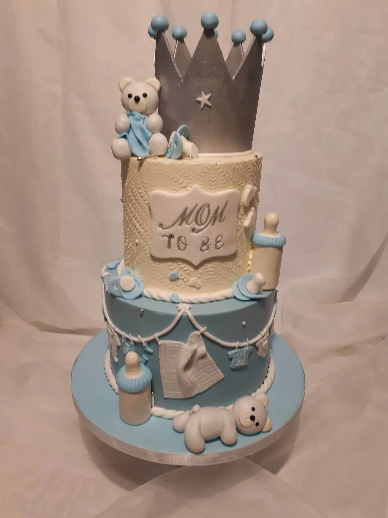 Two-tier blue cake for a mom-to-be