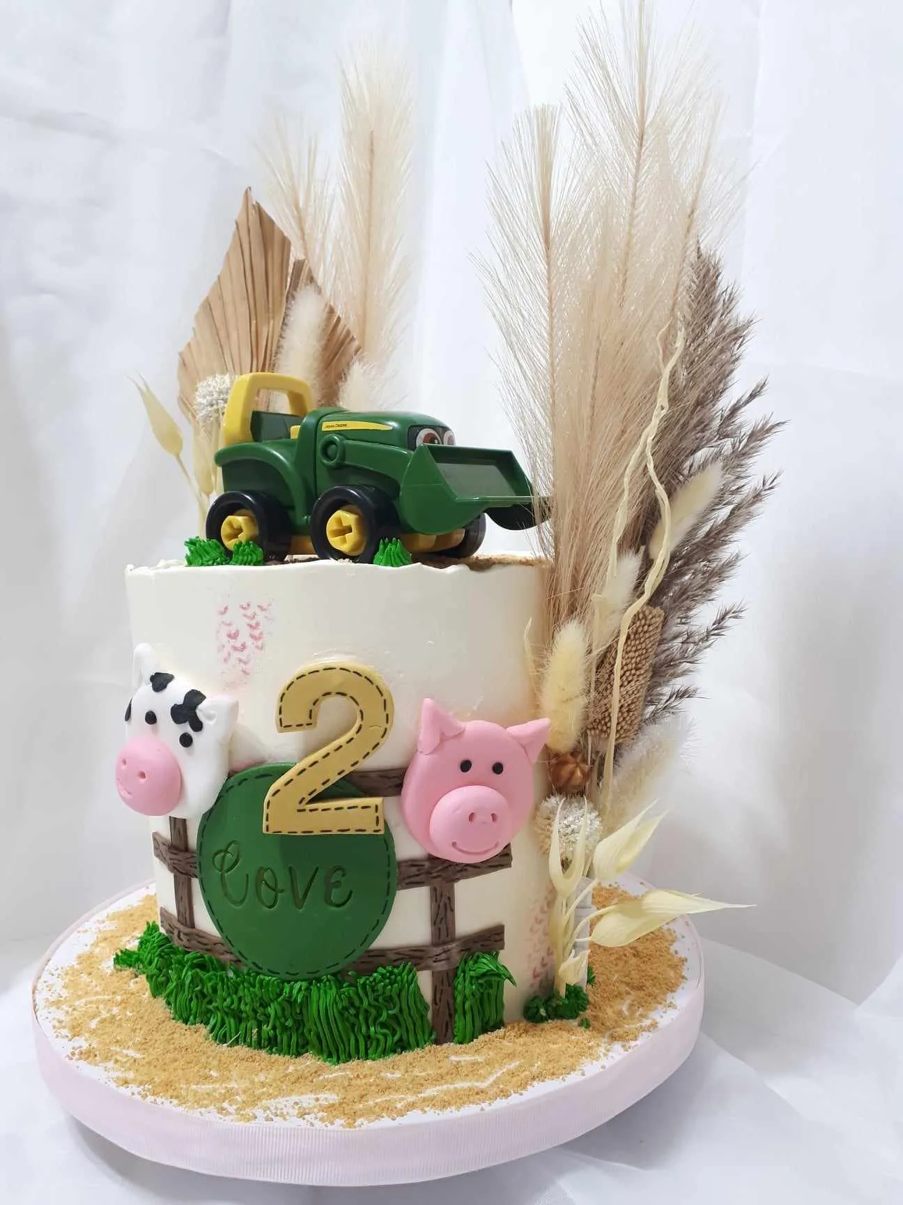 Farm birthday cake with a tractor, animals and the number 2