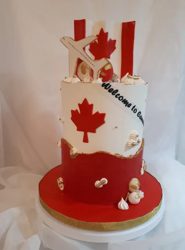 Red and white Canada flag cake with a welcome message